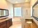 A bathroom features double sinks, granite countertops, and a tiled shower with a glass enclosure at 2809 112Th E Ter, Parrish, FL 34219