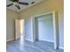 Large bedroom featuring vaulted ceiling, closet with bi-fold doors, wood-look flooring, and neutral colored walls at 2809 112Th E Ter, Parrish, FL 34219