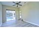 Bedroom with modern ceiling fan, luxury vinyl floors, neutral walls, and access to an outdoor pool area at 2809 112Th E Ter, Parrish, FL 34219