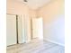 Neutral bedroom featuring pale pink walls, a closet, light-colored flooring, and a white door at 2809 112Th E Ter, Parrish, FL 34219