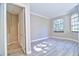 Bedroom with large window for natural light, neutral walls, luxury vinyl floors, and white trim at 2809 112Th E Ter, Parrish, FL 34219