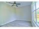 A bright bedroom with hardwood floors, a ceiling fan, and a large window at 2809 112Th E Ter, Parrish, FL 34219