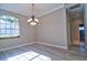 Dining room with wood floors, modern chandelier and bright window at 2809 112Th E Ter, Parrish, FL 34219