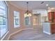 Dining room featuring luxury vinyl floors, pendant lighting, and an adjacent pool view through large windows at 2809 112Th E Ter, Parrish, FL 34219