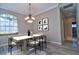 Modern dining room with stylish chandelier, large windows, and a contemporary table set for six at 2809 112Th E Ter, Parrish, FL 34219