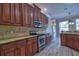 Beautiful kitchen featuring stainless steel appliances, custom cabinetry and backsplash, and an open layout at 2809 112Th E Ter, Parrish, FL 34219