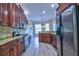 Well-lit kitchen with dark wood cabinets, granite counters, stainless steel appliances, and luxury vinyl floors at 2809 112Th E Ter, Parrish, FL 34219