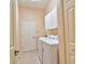 Laundry room with a utility sink, washer, dryer, overhead storage, and tile floors at 2809 112Th E Ter, Parrish, FL 34219