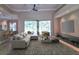 Open-concept living room featuring a large sectional sofa, entertainment center, and sliding glass doors to the outdoor space at 2809 112Th E Ter, Parrish, FL 34219