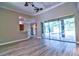 Open-concept living room with slider doors, offering seamless access to the screened pool area at 2809 112Th E Ter, Parrish, FL 34219