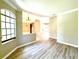 Bright living room featuring neutral walls, luxury vinyl floors, decorative light fixture, and ample natural light at 2809 112Th E Ter, Parrish, FL 34219