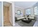 Bright and airy living room with neutral decor, large windows, and a decorative mirror at 2809 112Th E Ter, Parrish, FL 34219