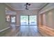 Spacious living room boasts wood floors, ceiling fans, and sliding glass doors to lanai and pool at 2809 112Th E Ter, Parrish, FL 34219
