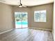 Living room with plank floors, sliders with pool views, and a ceiling fan at 2809 112Th E Ter, Parrish, FL 34219