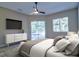 Spacious main bedroom featuring a comfortable bed, entertainment center, and sliding glass door to the pool area at 2809 112Th E Ter, Parrish, FL 34219