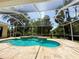 A screened in pool area with sparkling pool, attached spa and tiled deck has a private backyard view at 2809 112Th E Ter, Parrish, FL 34219