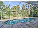 Enclosed pool area features a multilevel pool and lush tropical landscaping at 2809 112Th E Ter, Parrish, FL 34219