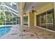 View of the screened-in pool and patio area with brick pavers and ceiling fan at 2809 112Th E Ter, Parrish, FL 34219