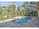 Relaxing screened pool with a waterfall feature, perfect for enjoying sunny days in privacy at 2809 112Th E Ter, Parrish, FL 34219