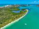 Aerial shot shows stunning tropical waterways and white sand beach at 290 N Washington Dr, Sarasota, FL 34236
