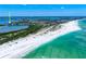 Stunning aerial view of a beachfront property with white sand and turquoise water at 290 N Washington Dr, Sarasota, FL 34236