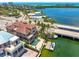 Gorgeous waterfront home featuring a private dock, backyard pool, and an outdoor lounge area with a covered patio at 290 N Washington Dr, Sarasota, FL 34236