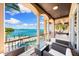 Balcony featuring stunning waterfront views, ornate columns, and outdoor seating at 290 N Washington Dr, Sarasota, FL 34236