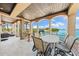 Beautiful balcony with water views, columns, and an outdoor dining table, perfect for entertaining at 290 N Washington Dr, Sarasota, FL 34236