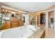Large soaker tub with granite surround, wooden cabinets and vanity with walk-in closet at 290 N Washington Dr, Sarasota, FL 34236