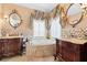 Elegant bathroom with dual vanities, soaking tub, decorative tile, and stylish fixtures at 290 N Washington Dr, Sarasota, FL 34236