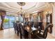 Formal dining room boasts an elegant chandelier, tray ceilings, and sliding glass doors offering water views at 290 N Washington Dr, Sarasota, FL 34236