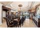 Formal dining area featuring an ornate chandelier, elegant decor, and water views at 290 N Washington Dr, Sarasota, FL 34236