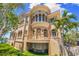 Luxurious home featuring a stucco facade, balcony, grand staircase and lush, green lawn at 290 N Washington Dr, Sarasota, FL 34236