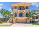 Impressive three-story home with detailed architectural features, a two-car garage and elegant landscaping at 290 N Washington Dr, Sarasota, FL 34236