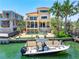 Beautiful waterfront home featuring lush landscaping, a boat dock, pool, and balcony at 290 N Washington Dr, Sarasota, FL 34236