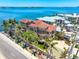 Elegant waterfront home with lush tropical landscaping, a beautiful driveway, and arched windows at 290 N Washington Dr, Sarasota, FL 34236