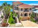 Expansive waterfront property with meticulously manicured landscaping, charming water fountain, and paver driveway at 290 N Washington Dr, Sarasota, FL 34236