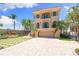 Striking home design with a stucco exterior, elevated balconies, and meticulously landscaped driveway at 290 N Washington Dr, Sarasota, FL 34236