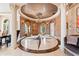 Grand foyer with a stunning starburst marble floor, chandelier, and arched doorway at 290 N Washington Dr, Sarasota, FL 34236