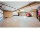 Spacious three car garage with epoxy flooring, storage shelving, and garage door openers at 290 N Washington Dr, Sarasota, FL 34236