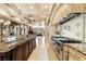 This gourmet kitchen features high-end stainless steel appliances and stone backsplash, and island sink at 290 N Washington Dr, Sarasota, FL 34236