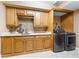 Well-equipped laundry room with modern appliances, ample cabinetry, and counter space at 290 N Washington Dr, Sarasota, FL 34236