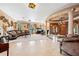Elegant living room with marble floors, columns, piano, and large windows at 290 N Washington Dr, Sarasota, FL 34236