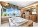 Spa-like main bathroom with a jacuzzi tub, waterfront views, custom cabinets, and granite counters at 290 N Washington Dr, Sarasota, FL 34236