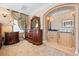 Elegant main bedroom offers a detailed dresser, decor, custom lighting, and hardwood furnishings at 290 N Washington Dr, Sarasota, FL 34236