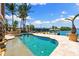 Inviting waterfront pool area with spa and lush tropical landscaping, perfect for relaxation and entertaining at 290 N Washington Dr, Sarasota, FL 34236