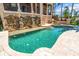 Luxurious outdoor pool and spa featuring a unique rock waterfall, creating a serene backyard oasis at 290 N Washington Dr, Sarasota, FL 34236