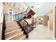 Spacious foyer with grand staircase featuring marble steps, iron railings, and deer head decorations at 290 N Washington Dr, Sarasota, FL 34236
