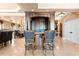 Custom wet bar with seating, cabinetry, granite countertops, and adjacent views of the dining room at 290 N Washington Dr, Sarasota, FL 34236