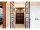 Ornate metal gate leads to a climate-controlled wine cellar with custom wood racks and lighting at 290 N Washington Dr, Sarasota, FL 34236